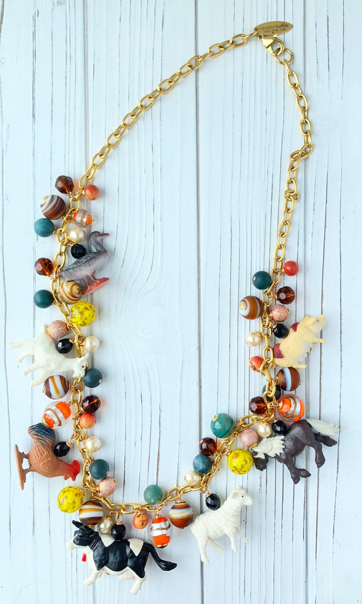 Long statement necklace with a mix of dark colored beads and farm animal charms. Charm necklace with farm animal charms.