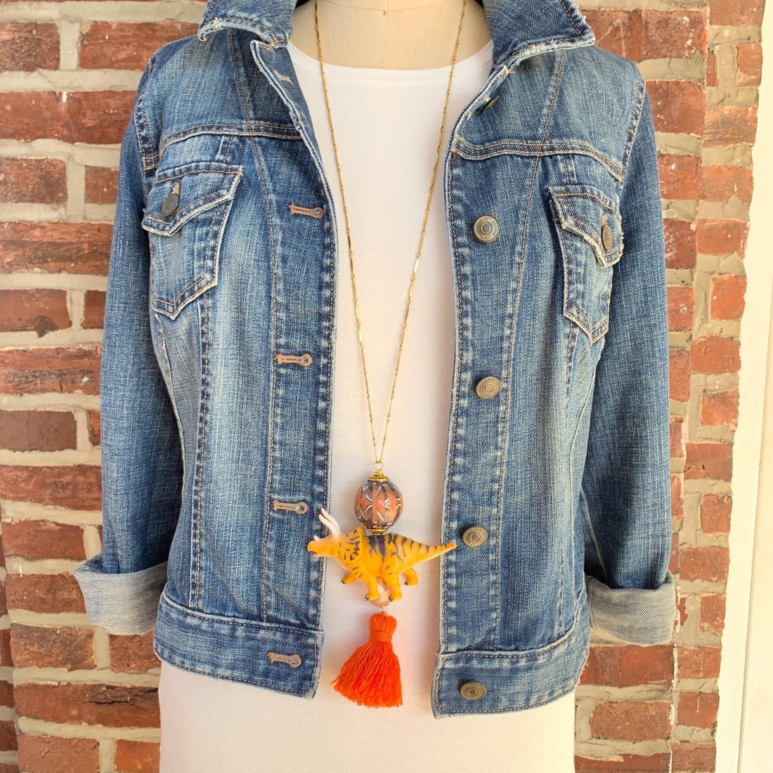 Triceratops pendant necklace for women. Dinosaur charm necklace on a gold chain.