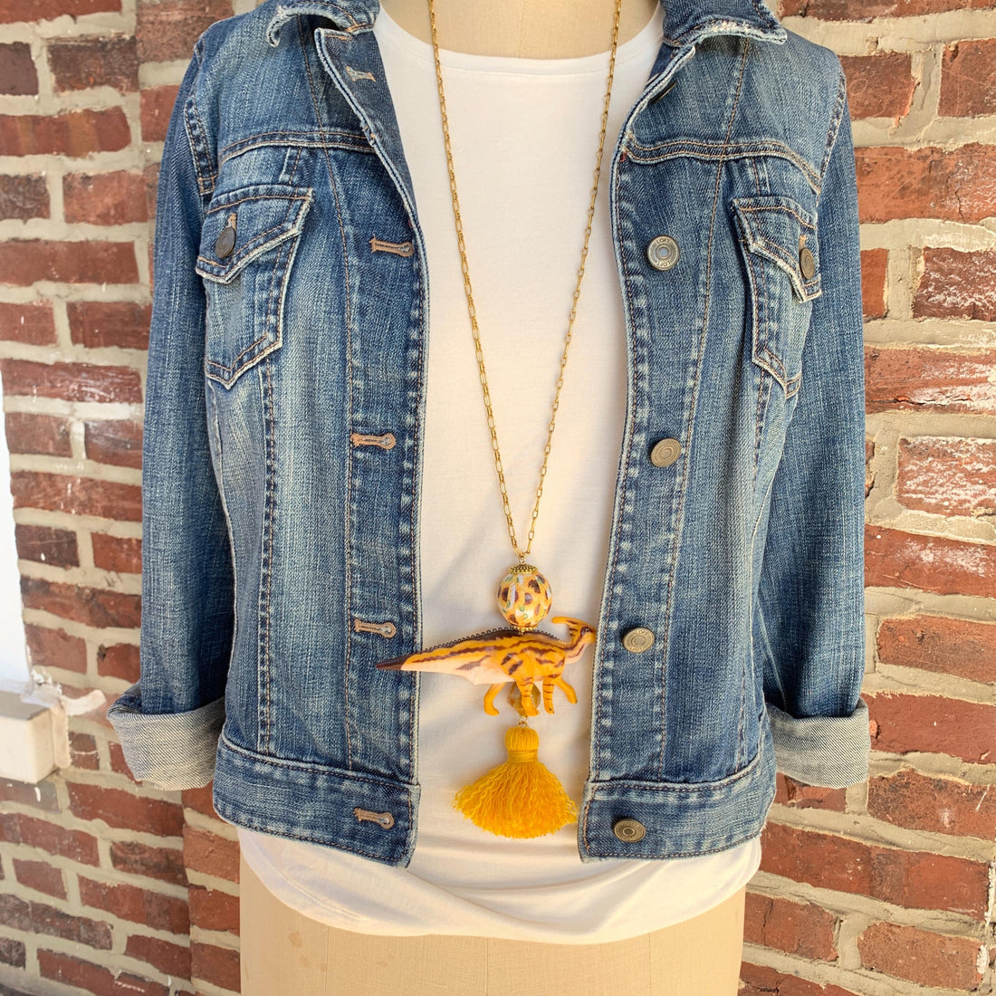 Gold dinosaur pendant necklace for women. Dinosaur charm necklace on a gold chain.