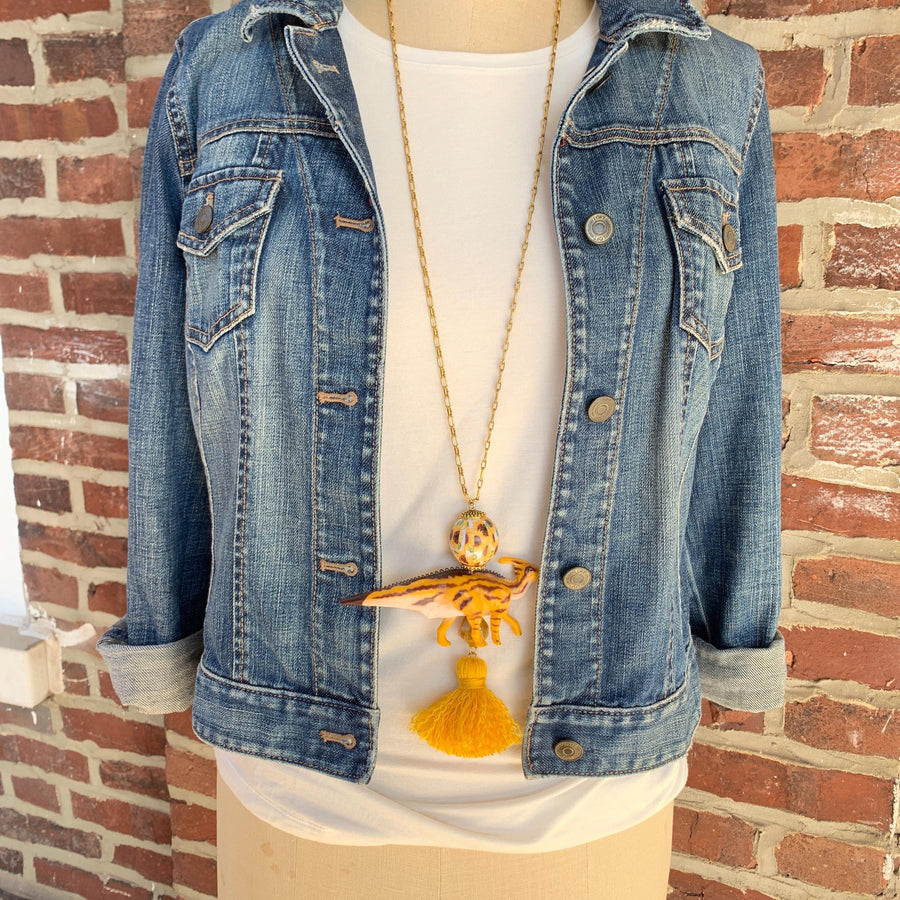 Gold dinosaur pendant necklace for women. Dinosaur charm necklace on a gold chain.