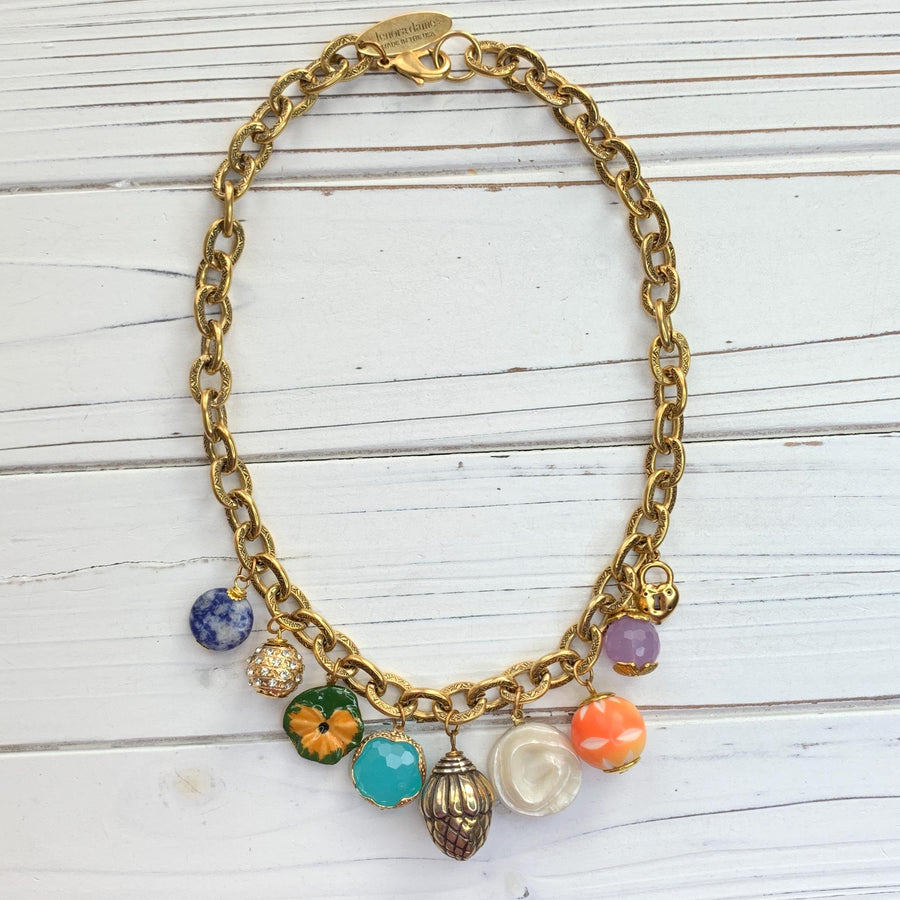 Trendy gold chain charm necklace with a mix of small charms. Vintage charms on a gold chain necklace for women.