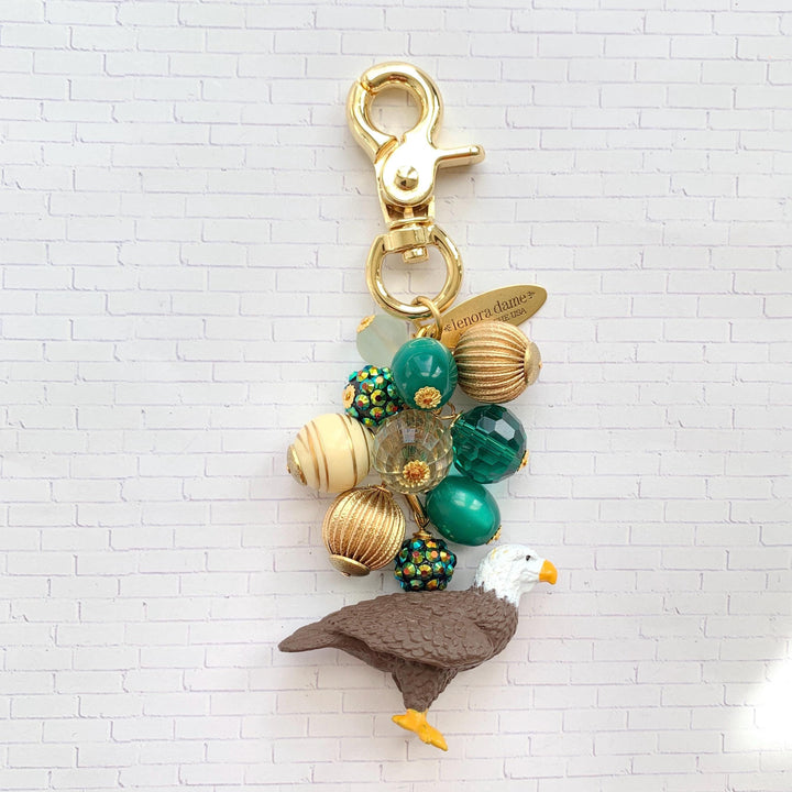 Philadelphia Eagles keychain with gold, and green beads, bald eagle figurine and gold trigger clasp. Philadelphia Eagles purse charm.