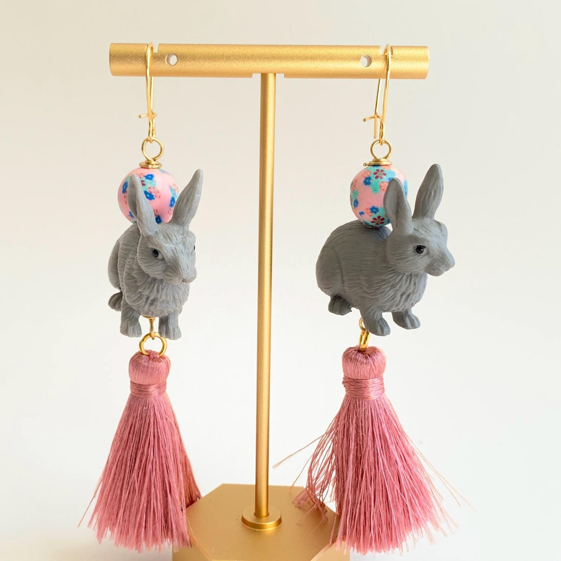 Bunny earrings for Easter. Cute bunny rabbit statement earrings with grey bunnines, floral beads, and pink silk tassels.