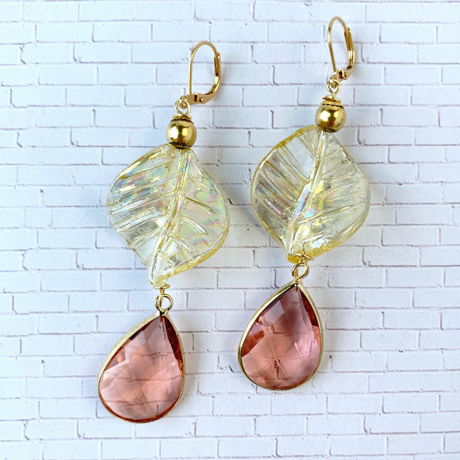 Lenora Dame earrings Gold tone drop earrings with iridescent twisted leaves and tear drop faceted peach crystals.