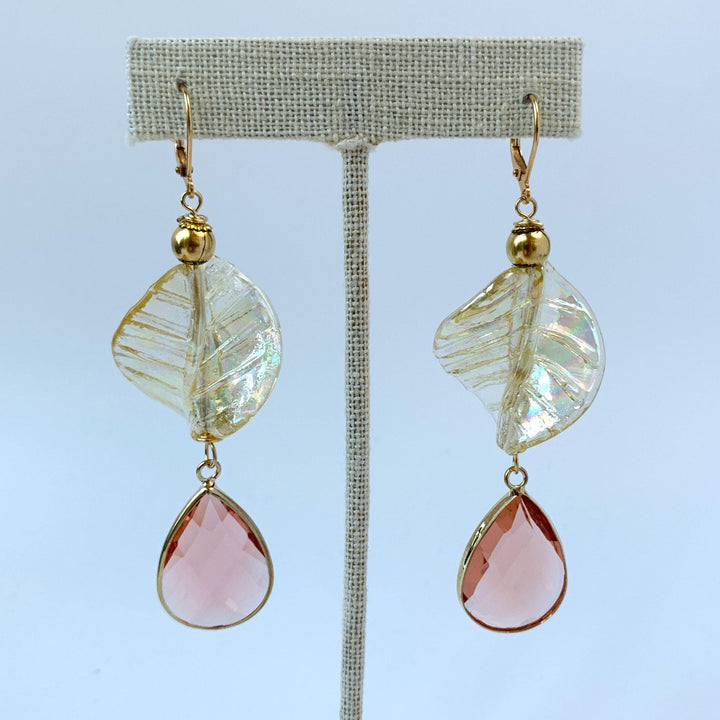 Lenora Dame earrings Gold tone drop earrings with iridescent twisted leaves and tear drop faceted peach crystals.