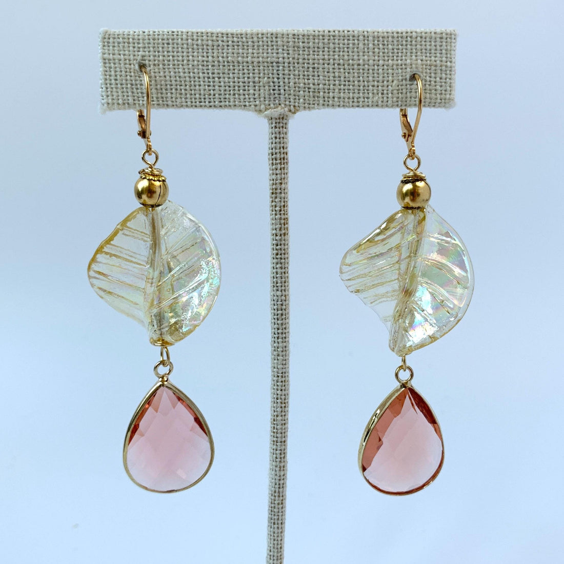 Lenora Dame earrings Gold tone drop earrings with iridescent twisted leaves and tear drop faceted peach crystals.