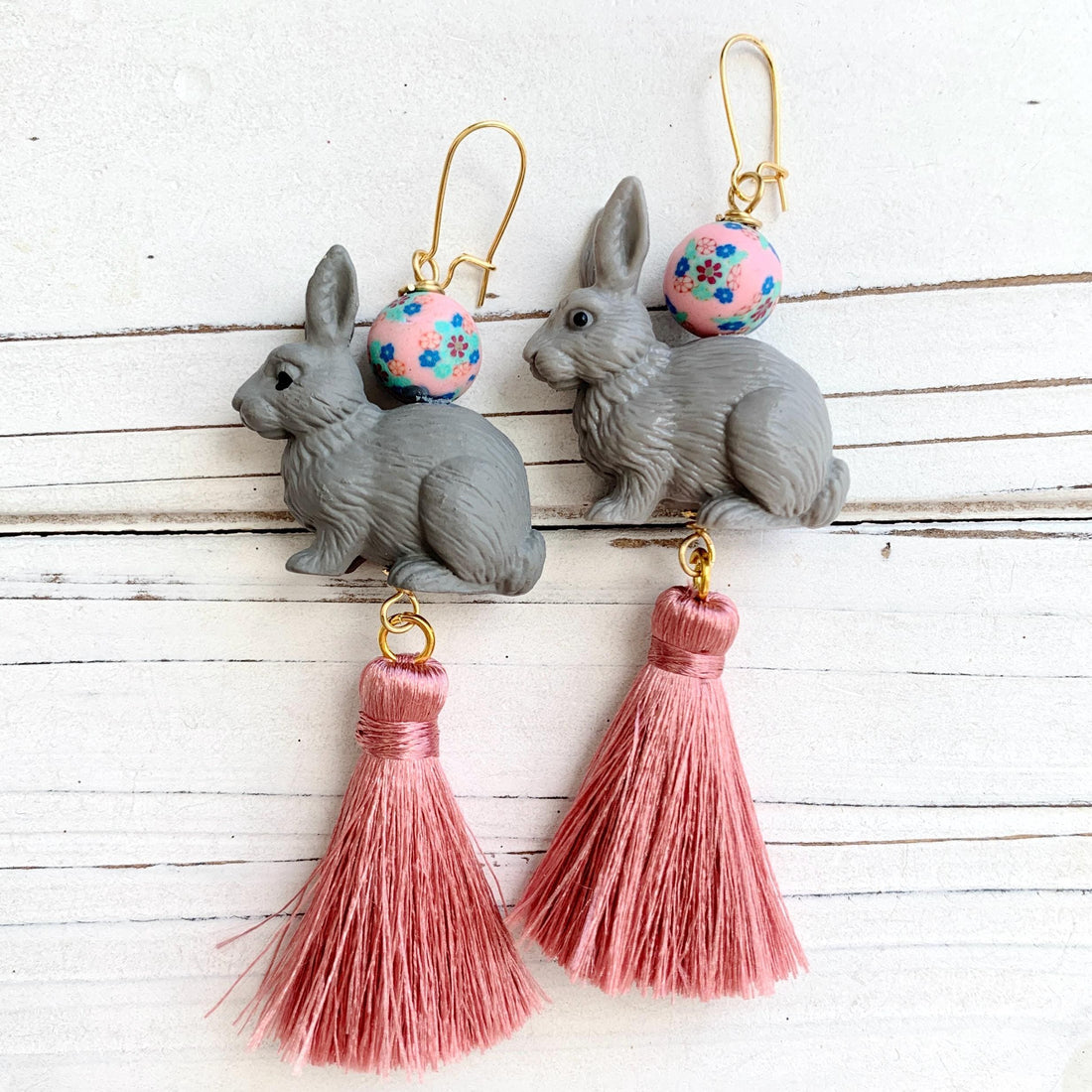 Bunny earrings for Easter. Cute bunny rabbit statement earrings with grey bunnines, floral beads, and pink silk tassels.