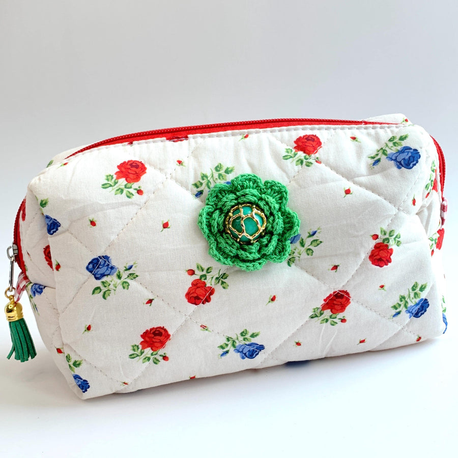 Red and blue flowers on white cotton fabric quilted zipper pouch embellished with a green crochet flower with a vintage earring center. Quilted makeup bag. Cute makeup bags with zipper. Gifts for mom.