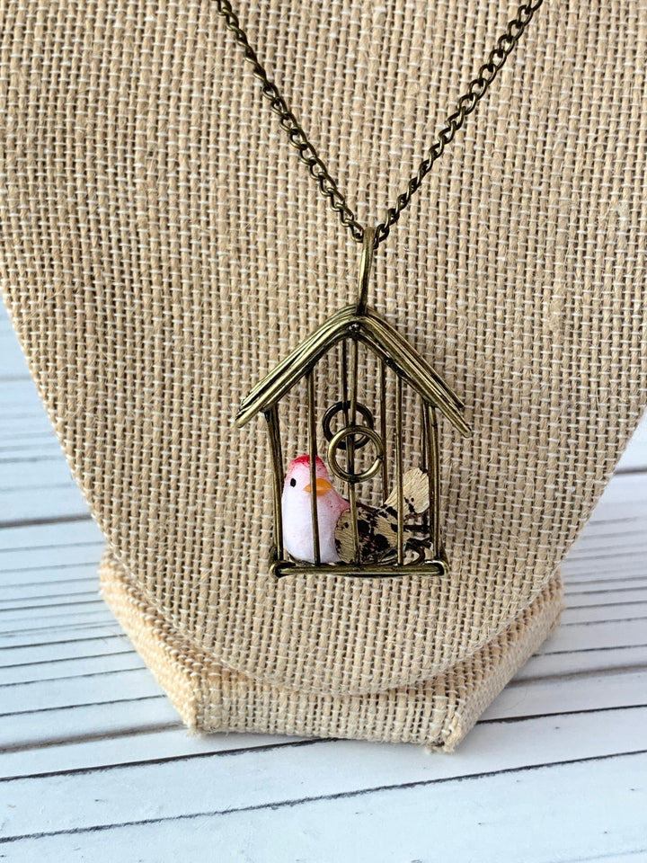 Lenora Dame A Little Bird Told Me Birdcage Pendant Necklace in Coral