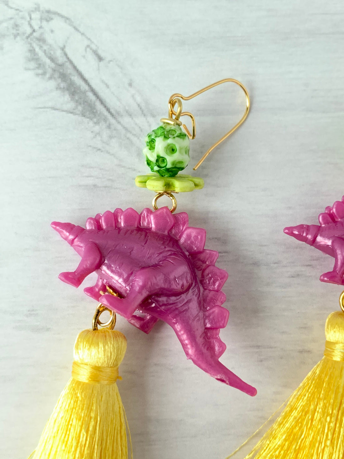 Lenora Dame Orchid Stegosaurus Tassel Earrings