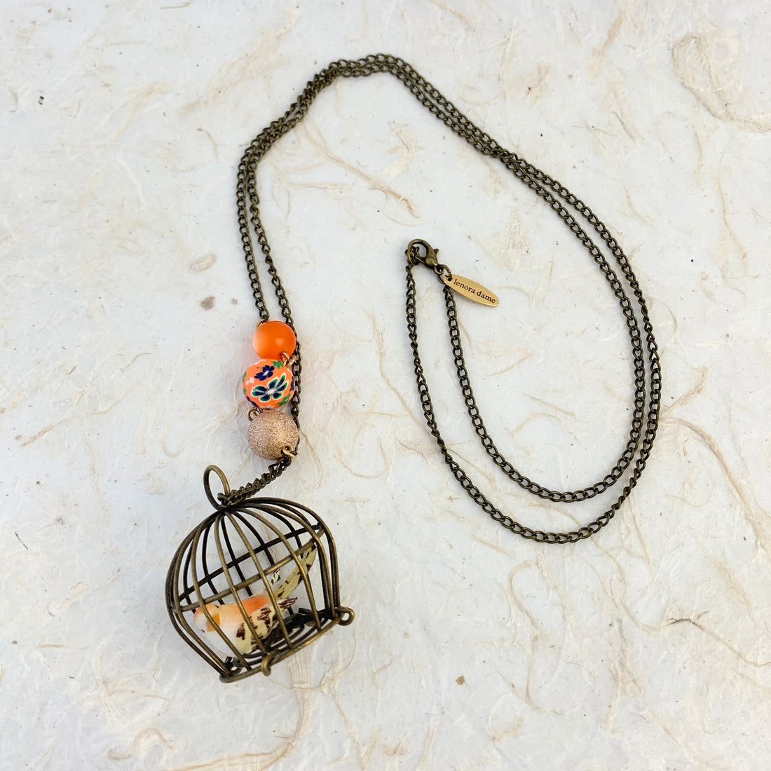 Lenora Dame Little Bird In A Vintage Birdcage Pendant Necklace in Begonia