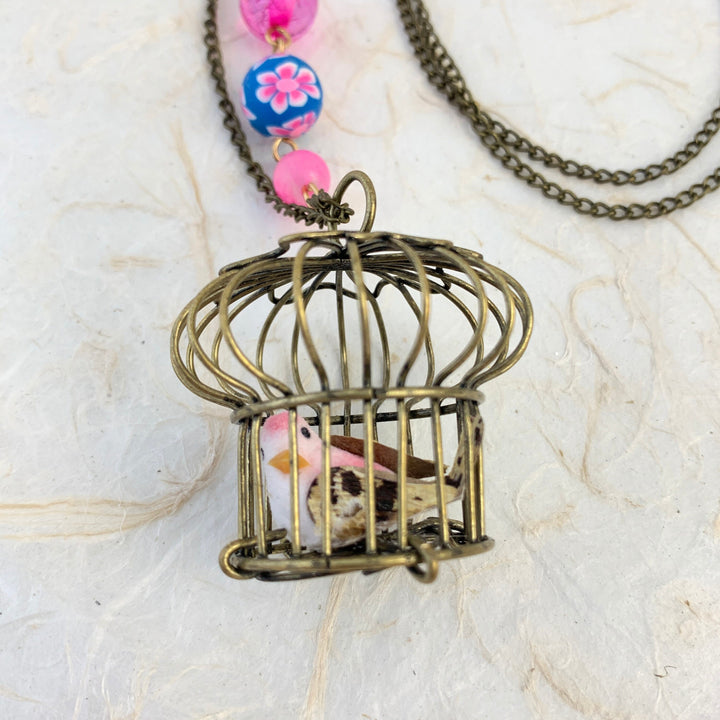 Lenora Dame Little Bird In A Vintage Birdcage Pendant Necklace in Roseate